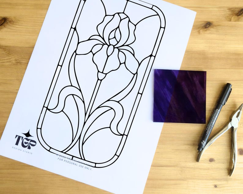 Black and white iris pattern printout with glass and tools